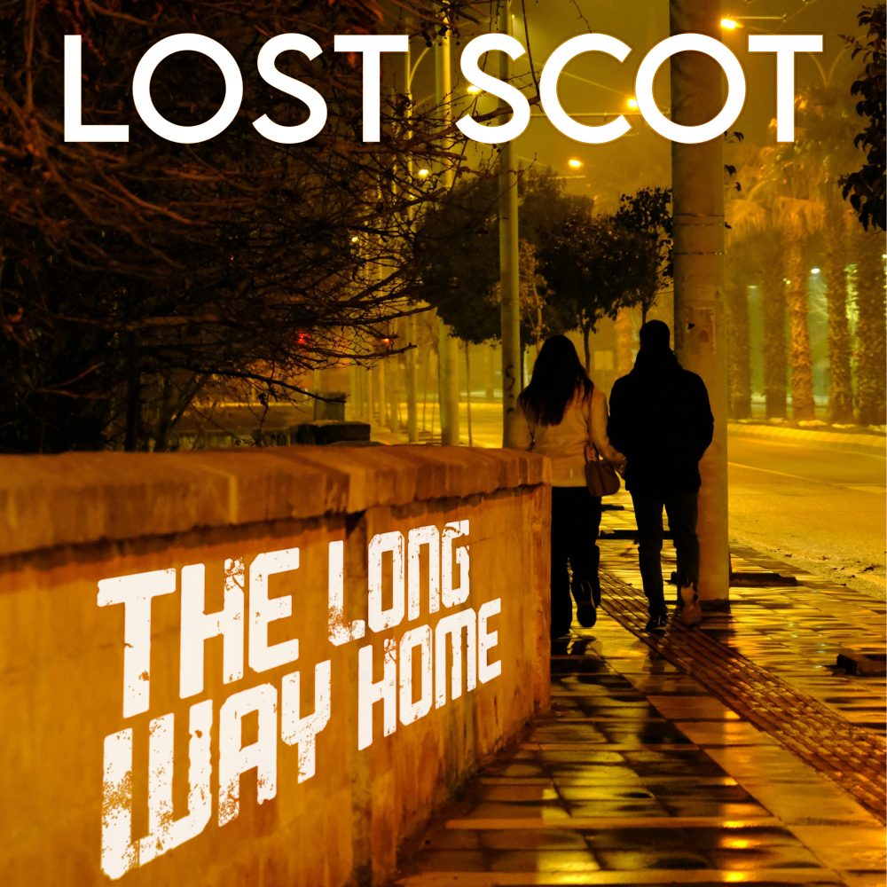An evening quiet city scene. Two people are walking away from the camera past a waist high wall. At the top it says "Lost Scot" and "The Long Way Home" is written along the wall.
